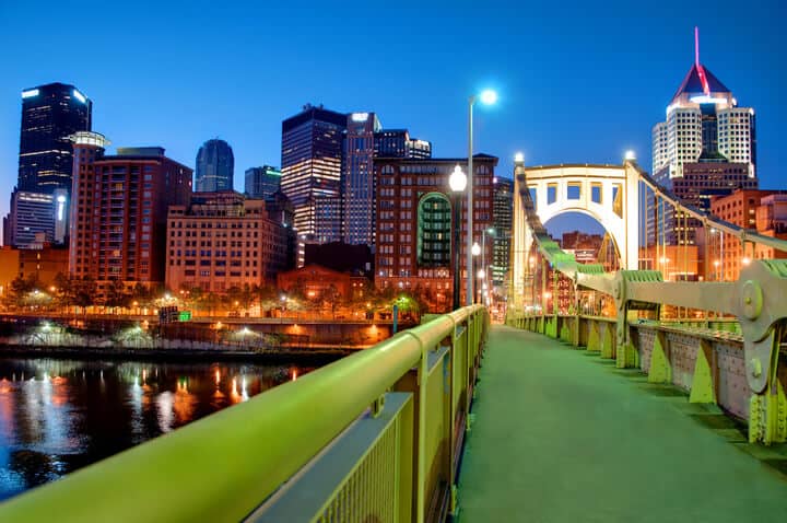 A view of the Pittsburgh, Pennsylvania cityscape at night from the Roberto Clemente Bridge overlooking the Allegheny River.