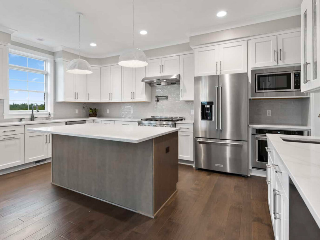 modern custom kitchen with large island and brand new appliances