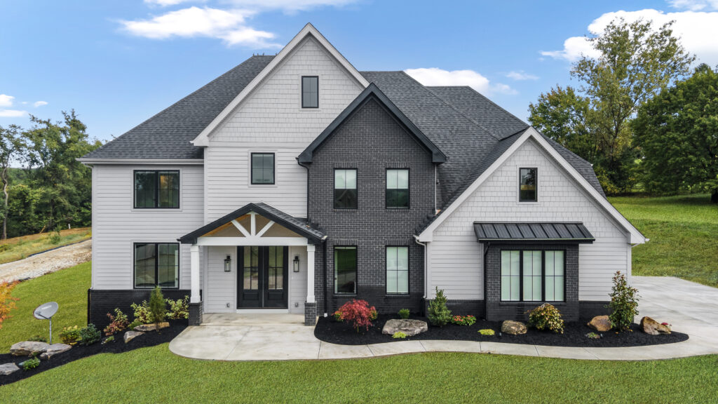 two-tone custom built home with black brick and gray siding